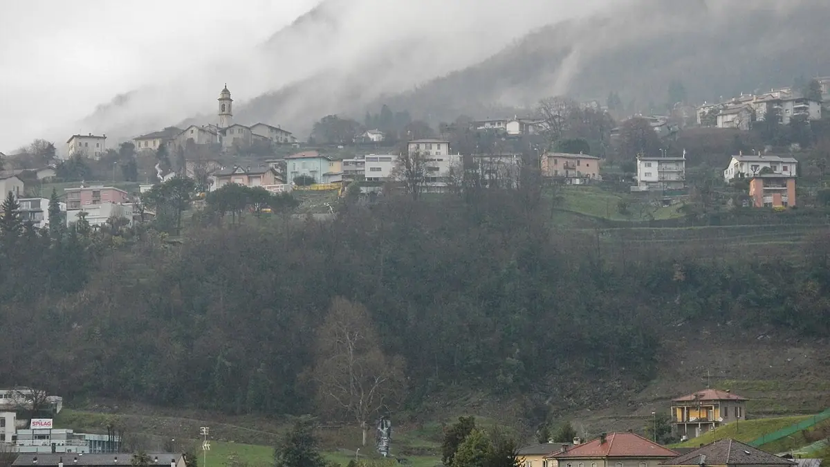 Aerial view of Chiasso with Swiss-Italian border crossing and A2 highway traffic at dusk