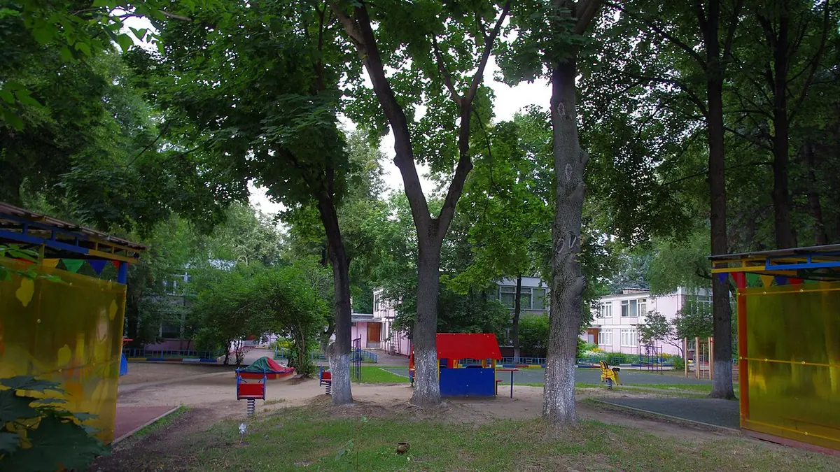 Swiss kindergarten classroom with colorful toys and children's drawings on walls